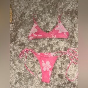 Cute pink, with white flowered details, bikini.